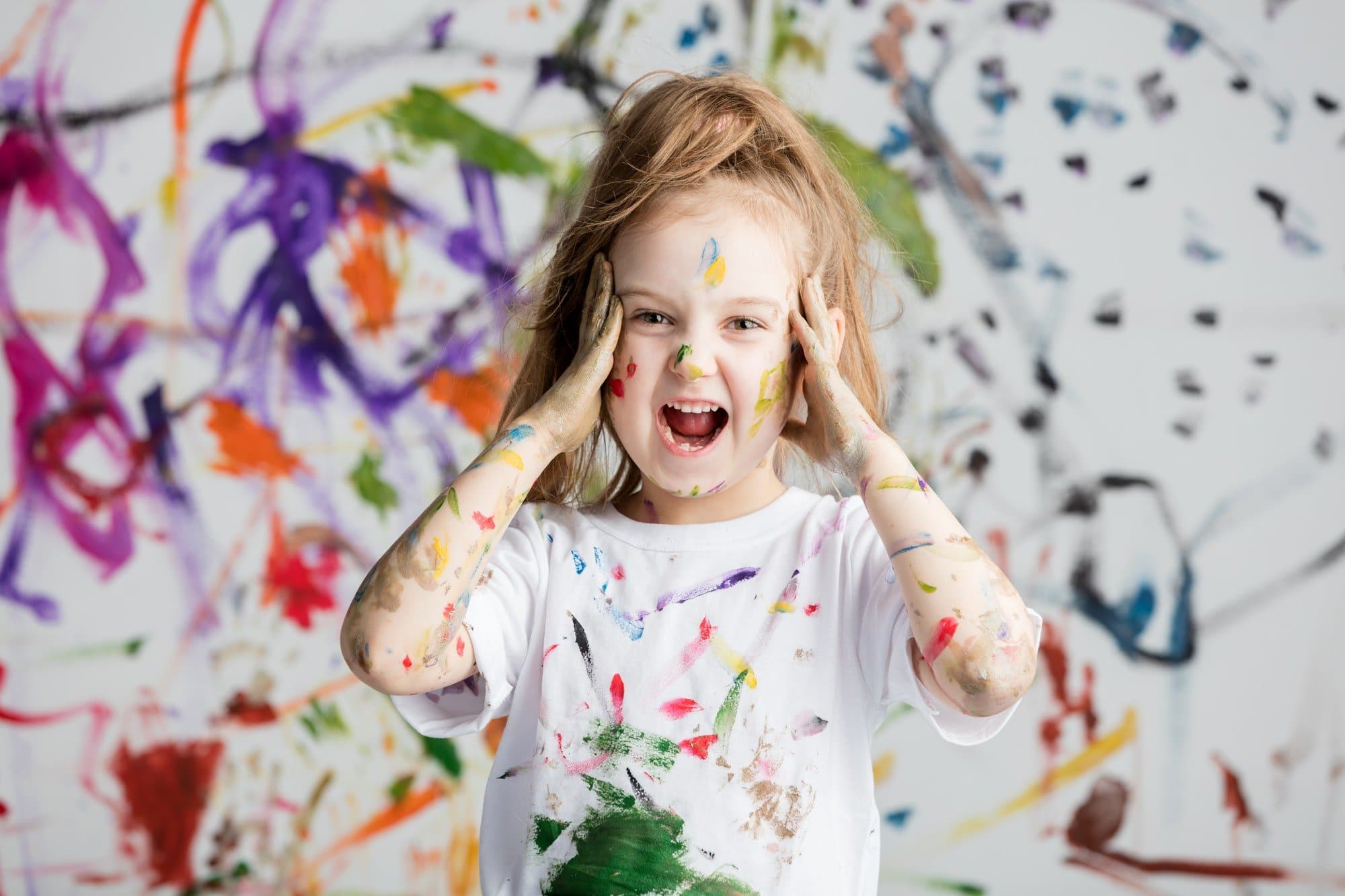 Shocked little girl grabbing her head