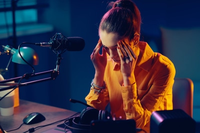 Tired radio host with headache