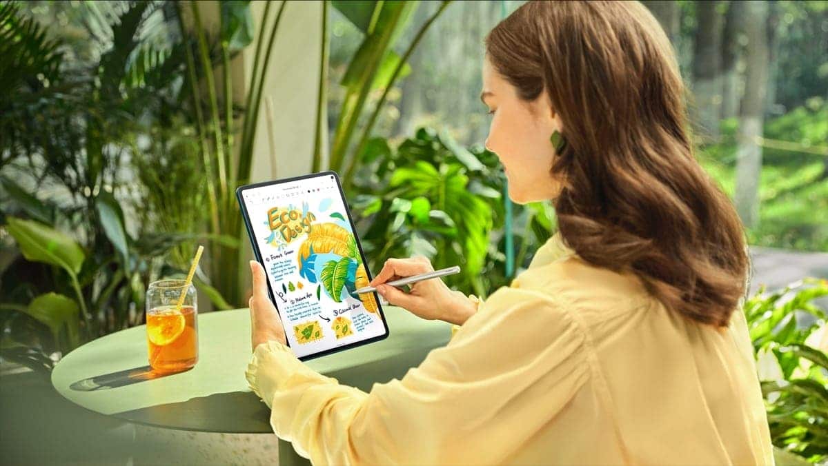 A person sitting at a table reading a bookDescription automatically generated with medium confidence