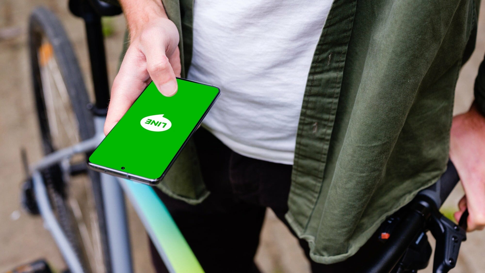 Mockuuups holding samsung s20 mockup in front of a bike