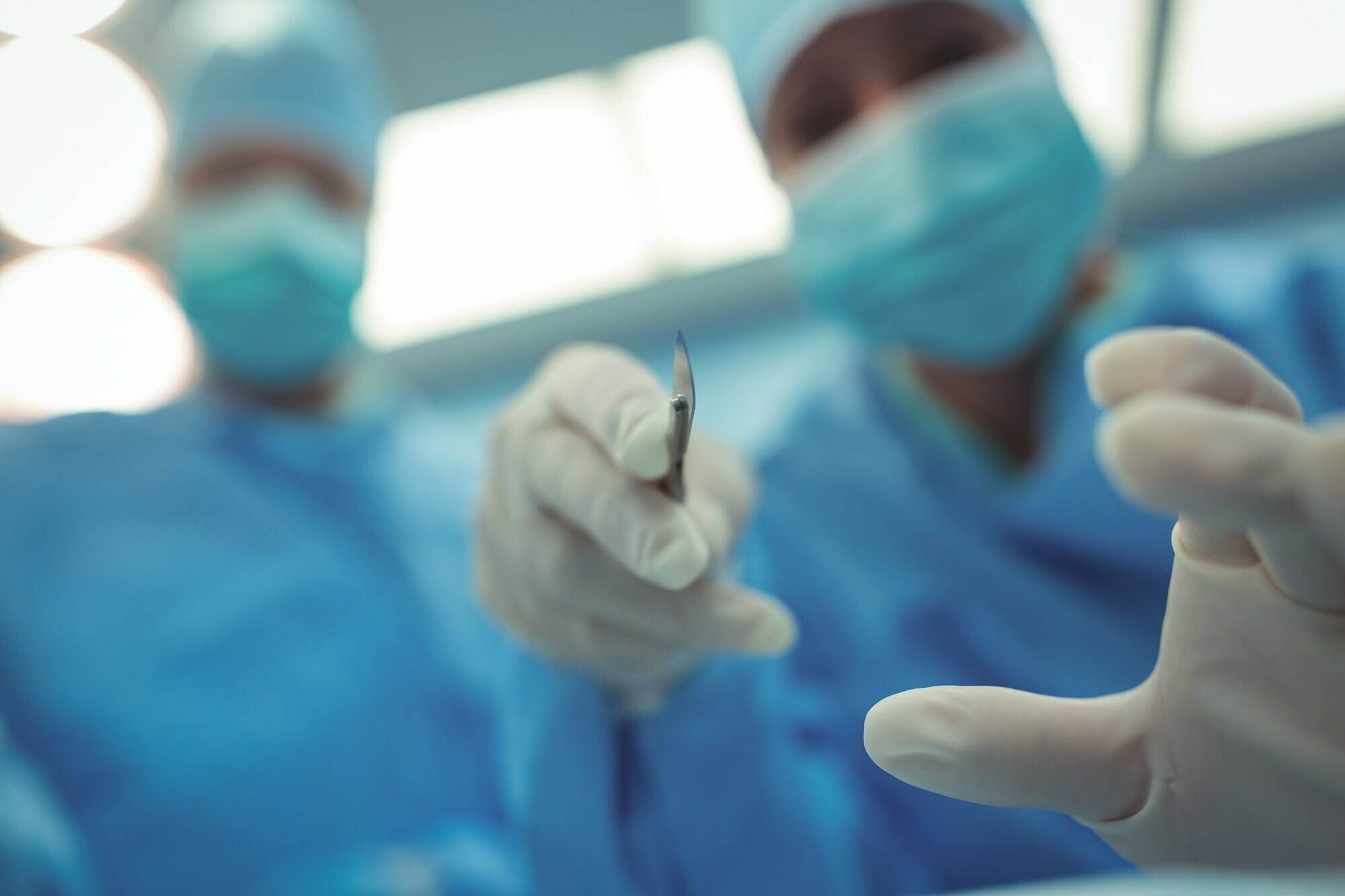 Surgeon with scalpel performing operation in operation theater